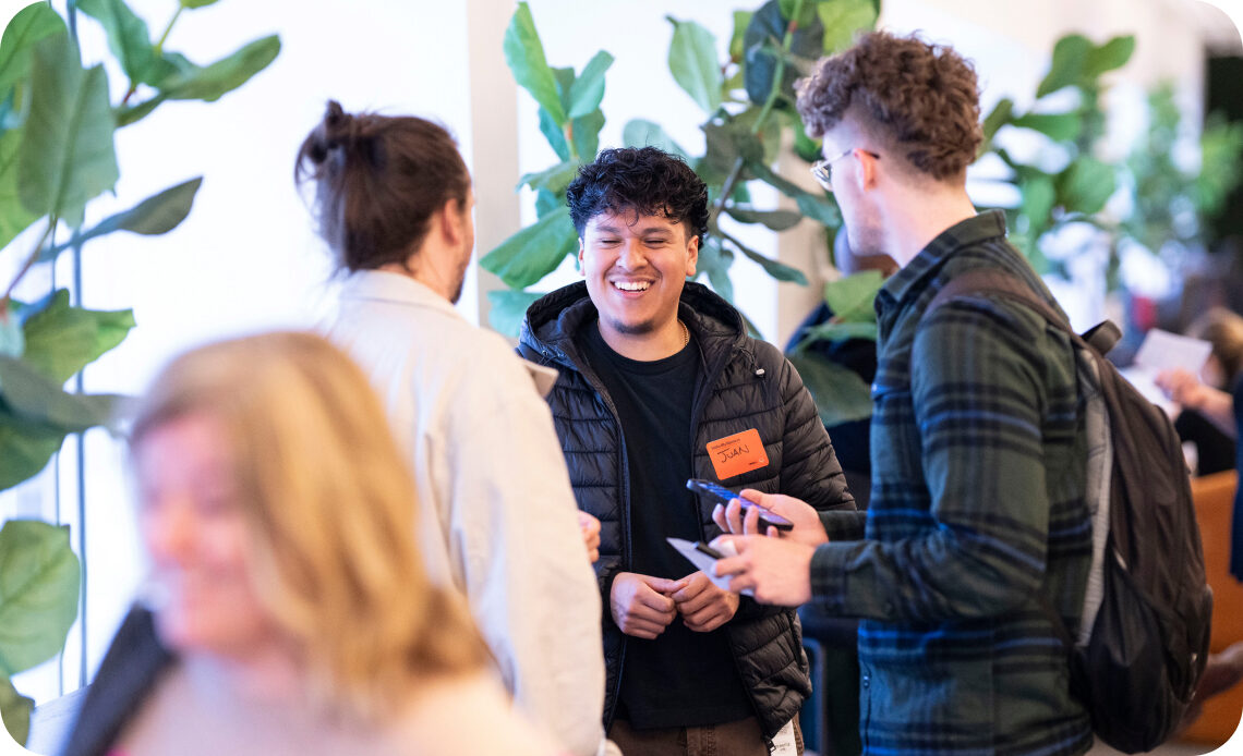 Young Omnicom professionals talking together at a networking event