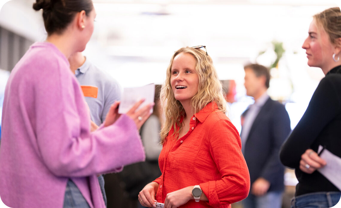 Omnicom colleagues in conversation at a networking event
